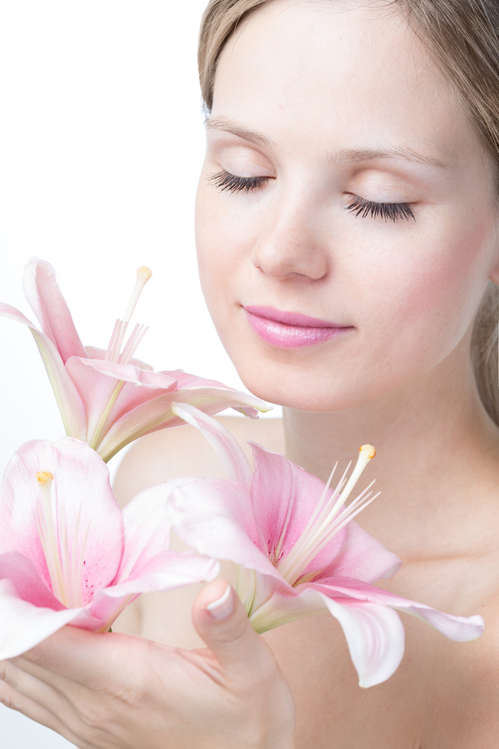 Face of a beautiful young woman with lily